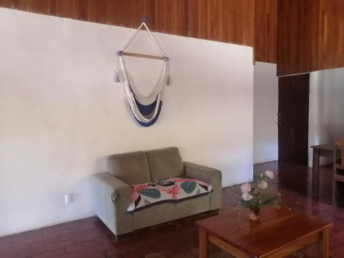a couch in a living room with a blanket on a wall at Almendros House in Coco