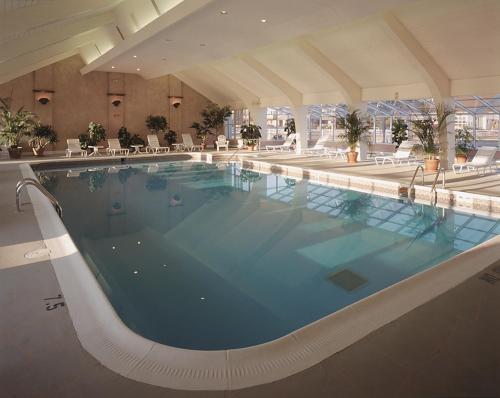 a large swimming pool in a hotel building at The Newport Harbor Hotel & Marina in Newport