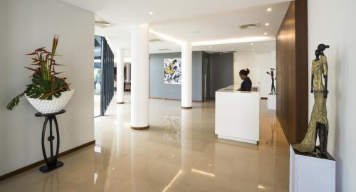 a woman standing at a counter in a museum at Fiesta Residences Boutique Hotel and Serviced Apartments. in Accra