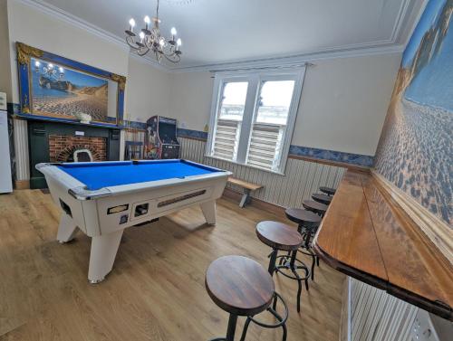 a room with a pool table and some stools at Jurassic Bay Holidays in Weymouth