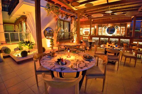 uma sala de jantar com mesas e cadeiras num restaurante em west coast boutique hotel em Bodrum City