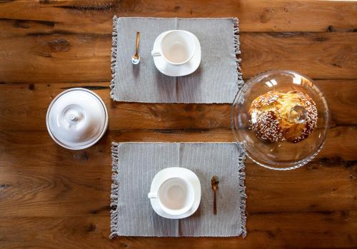 a table with white plates and a bowl of food at Casa Anna in Trichiana