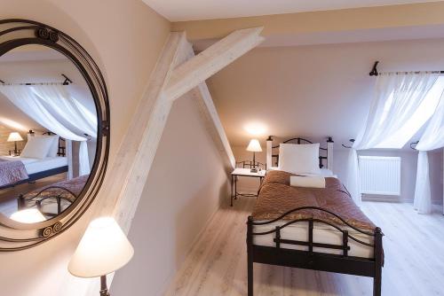 a bedroom with two beds and a mirror at Penzion Na Palubě in Jeseník