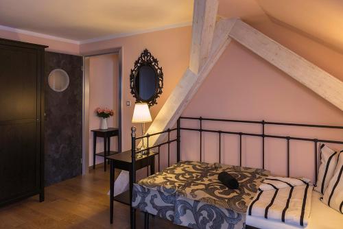 a bedroom with a bed and a mirror on the wall at Penzion Na Palubě in Jeseník