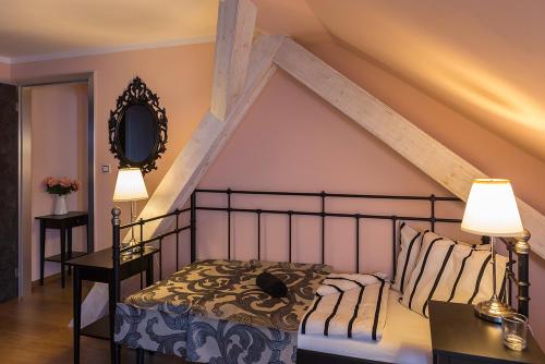 a bedroom with a bed and two tables with lamps at Penzion Na Palubě in Jeseník