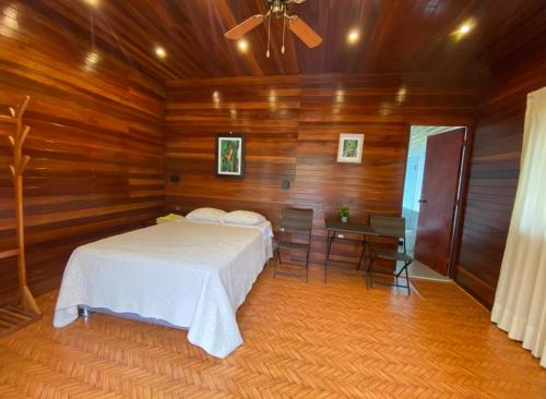 a bedroom with a bed and a table and a ceiling at Green Paradise Bungalows in Las Palmas