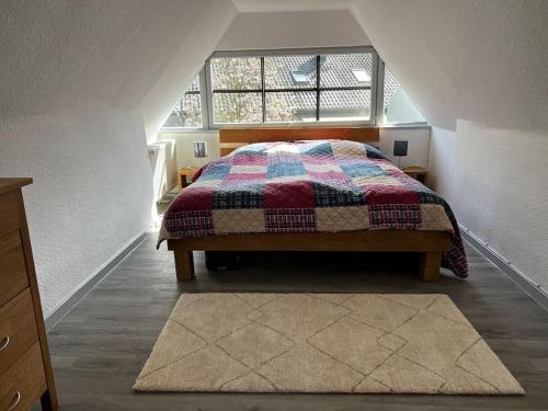 a bedroom with a bed in a attic at Cottage mit Garten in Michendorf