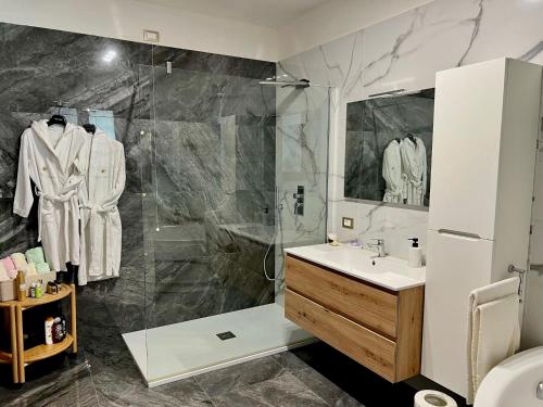 a bathroom with a shower and a sink at Terrazza Levante - Boutique rooms in Otranto