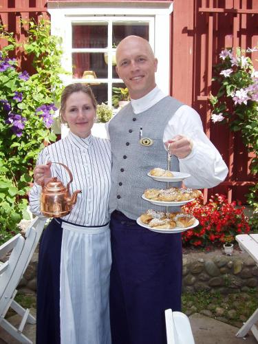 a man and a woman holding a plate of food at Garvaregården Hotel , B&B och Café in Askersund