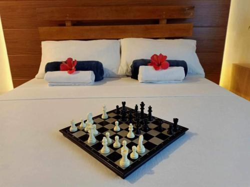 a chess board sitting on top of a bed at GBU Loboc River Guesthouse in Loboc