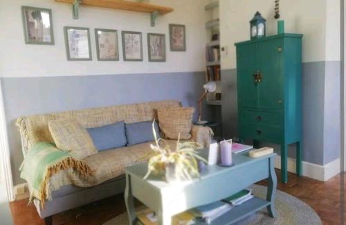 a living room with a couch and a green cabinet at Ferienwohnung für 4 Personen ca 48 qm in London, England South East England in London