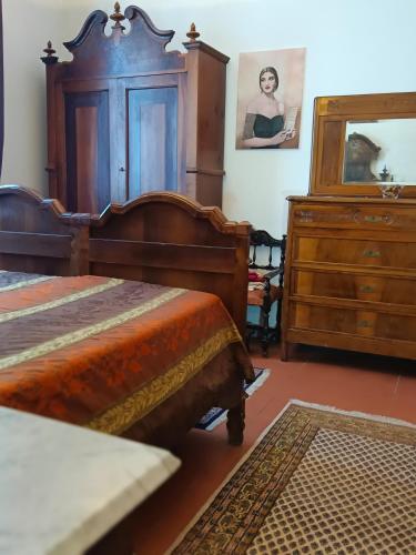 a bedroom with two beds and a dresser at La Maison Rouge in Crespellano