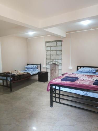 a room with two beds and a fireplace at Homestay Darjeeling in Darjeeling