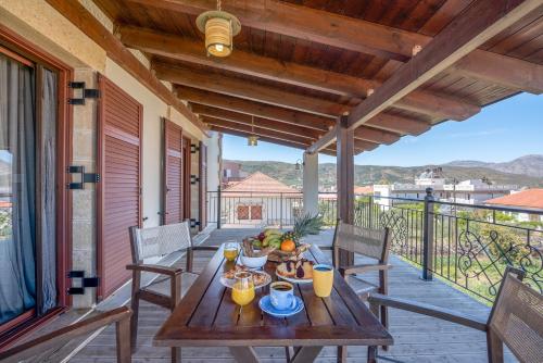 a wooden table on the porch of a house at Secreto Studios in Kissamos