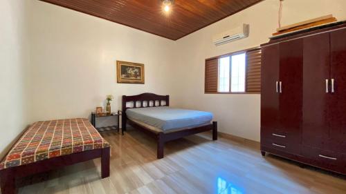 - une chambre avec un lit et une commode dans l'établissement Reserve Temporada - Chácara 01, à Olímpia