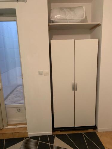 a white cabinet in a room with a closet at La Pause in Lormont