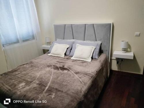 a bedroom with a large bed with two pillows at casa sousa in Campanário