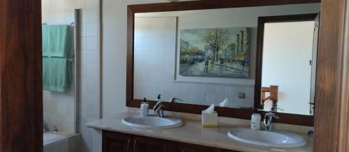 a bathroom with two sinks and a large mirror at AKASHA in Puerto del Rosario