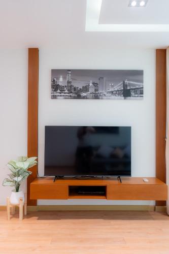 a living room with a large flat screen tv at Patong Kalim Unparalleled Sea View B&B Resort in Patong Beach