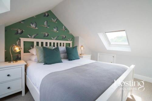 a bedroom with a large bed with green walls at Marlow's Hidden Gem in Marlow