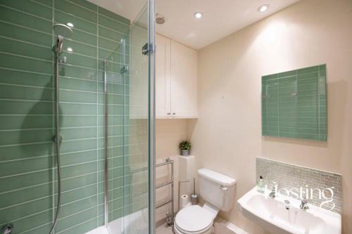 a bathroom with a shower and a toilet and a sink at Station House in Marlow