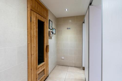 a hallway with a wooden door in a room at Patong Kalim Unparalleled Sea View B&B Resort in Patong Beach