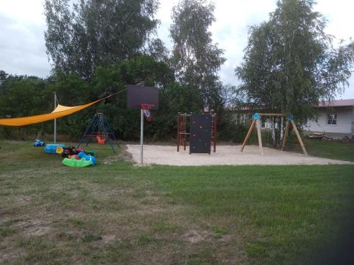 a playground with a basketball hoop and swings at Ein Hauch von Orient in Eggesin