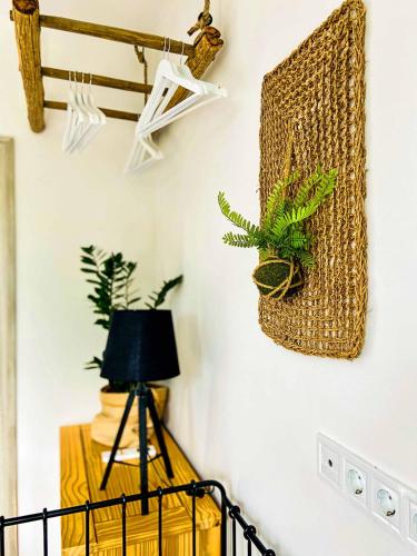 a room with plants on the wall and a lamp at Lessük meg! Vendégház - Sümeg in Sümeg
