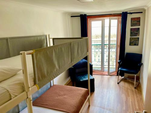 a bedroom with two bunk beds and a balcony at Lisbonaccommodation in Lisbon
