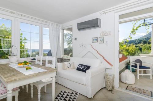 a living room with a white couch and a table at Ferienwohnung für 2 Personen ca 50 qm in Orebić, Dalmatien Süddalmatien in Orebić