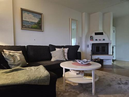 a living room with a couch and a table at Lägenhet i Älvsborg Göteborg in Gothenburg