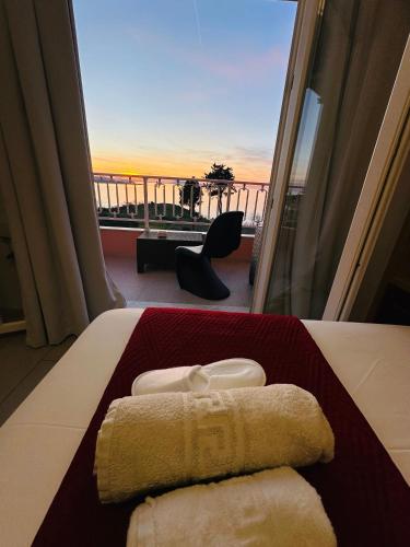 a hotel room with a bed with two towels on it at Nikos Apartments Corfu in Agios Stefanos