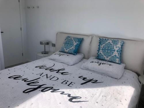 a bed with two pillows on top of it at Luxury apartment with stunning terrace and with heated pool in Adeje