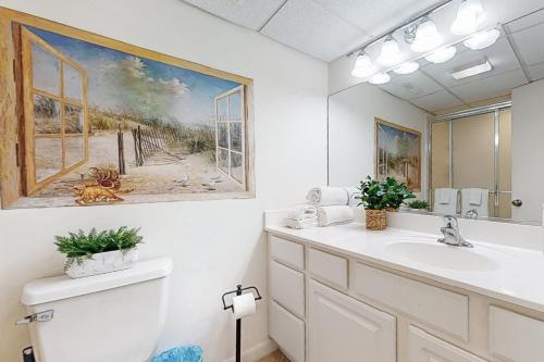 a bathroom with a sink and a painting on the wall at Starboard Tack 1A in Ocean City