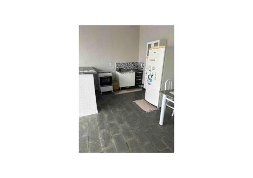 una stanza vuota con cucina e frigorifero di kitnet/Loft/Edícula ampla Aracatuba/Birigui ad Araçatuba