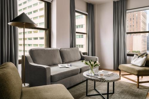 a living room with a couch and a chair at Sonder Duane Street in New York