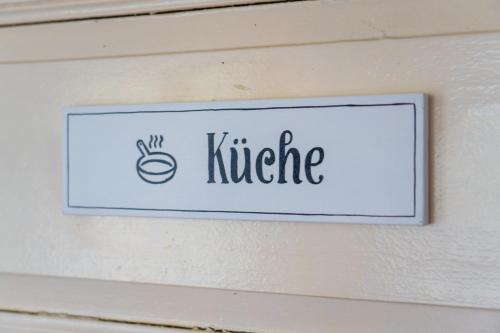 a sign on a wall with a coffee sign on it at Alandblick in Wanzer