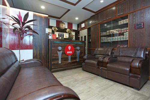 a waiting room with leather couches and a stop sign at Super Hotel O Cherry City Cottage in Guwahati