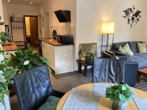 a living room with a couch and a table at Apartment mit Seeblick in Feld am See