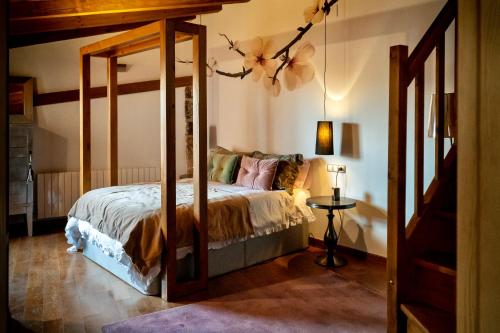 a bedroom with a canopy bed in a room at Hotel Rural Flor de Almendro in Loarre