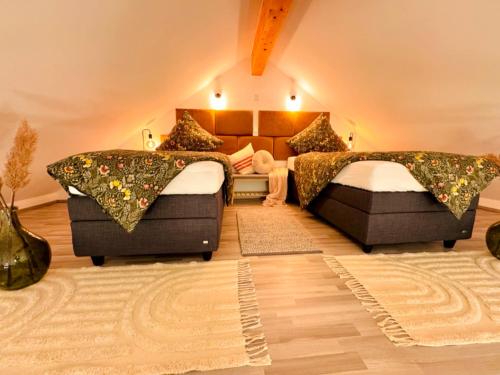 a large room with two beds and a couch at Galeriewohnung Vierseithof in Eging am See