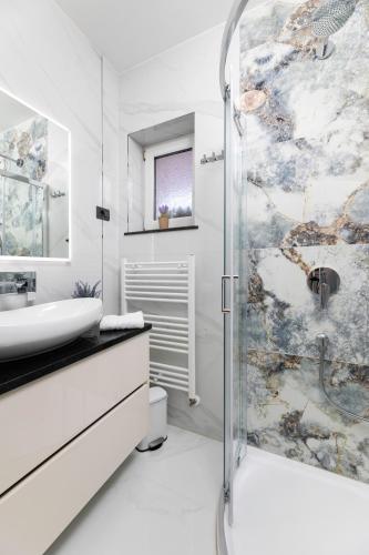 a bathroom with a shower and a sink at Villa Beganović in Krk