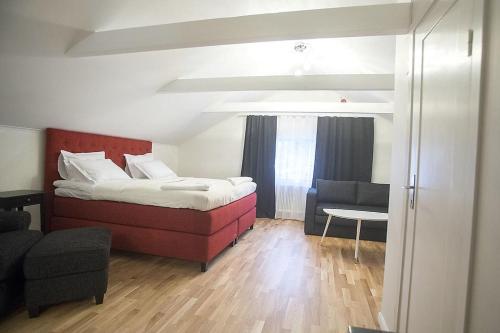 a bedroom with a bed and a living room at Hotell Kungsbacken in Katrineholm