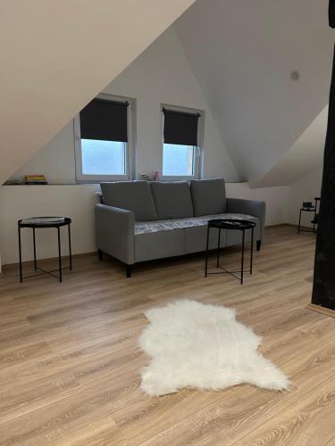 uma sala de estar com um sofá e um tapete branco em Modernes Loft am Dreiländereck em Alsdorf