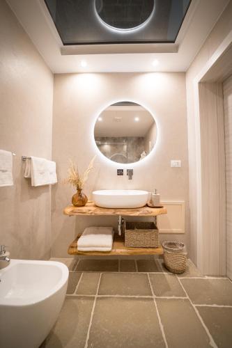 a bathroom with a sink and a mirror at Guerrieri Suites & Spa in Campi Salentina