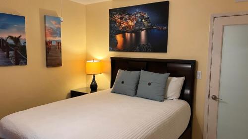 a bedroom with a bed and a painting on the wall at Billy's Resort-Clothing Optional- Men Only - Solo Hombres in Wilton Manors