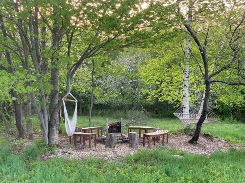 a park with a playground with benches and a swing at Journeys End Chalet - Minutes to Jay Peak! in Jay