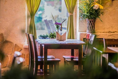 a dining room table with chairs and flowers on it at Złoty Lin in Serock