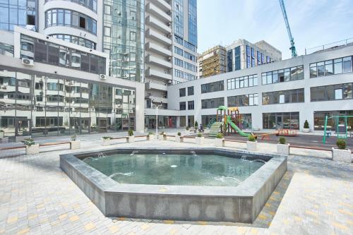 a large pool of water with a playground in a city at Gagarin Plaza Luxury Sea View Apartments in Odesa