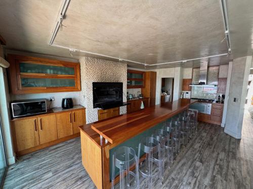 a large kitchen with a long wooden counter top at Cozy family beachfront house. in Langstrand